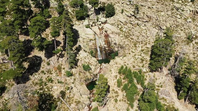 The Cascades de Radule in the middle of the rocky and arid mountains, in Europe, in France, in Corsica, towards Ajaccio, by the Mediterranean Sea, in summer, on a sunny day.