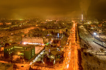 Fototapeta na wymiar Aerial view of the town and Shmidta street on polar night. Murmansk, Russia.