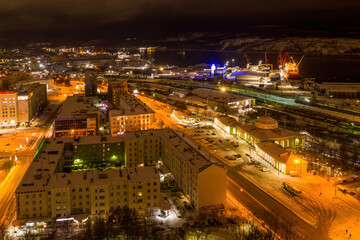 Aerial view of the town, railway station and sea port on polar night. Murmansk, Russia.