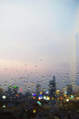 Ho Chi Minh City Skyline viewed through window with rain drops during sunset hour