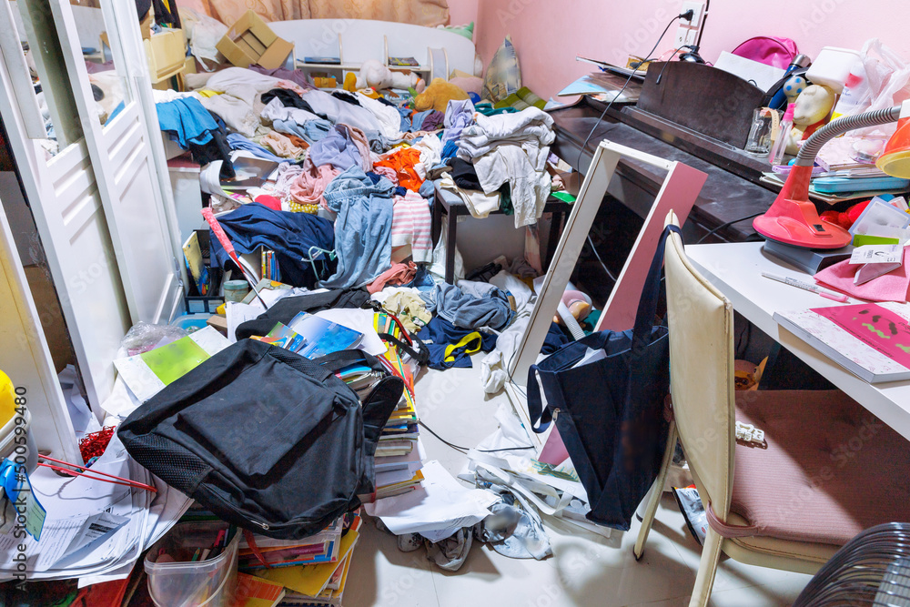 Wall mural A room cluttered with piles of clothes