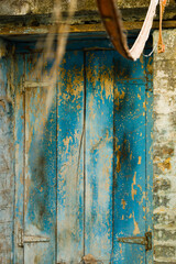 Old blue door with peeling paint in Pune, India