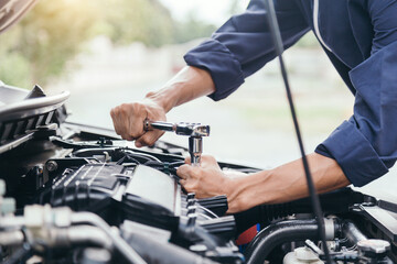 Automobile mechanic repairman hands repairing a car engine automotive workshop with a wrench, car service and maintenance,Repair service.