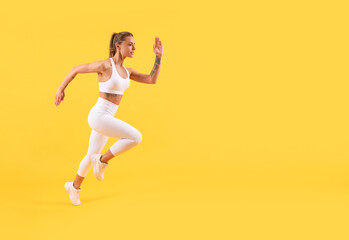 Fototapeta na wymiar fitness girl runner running on yellow background with copy space