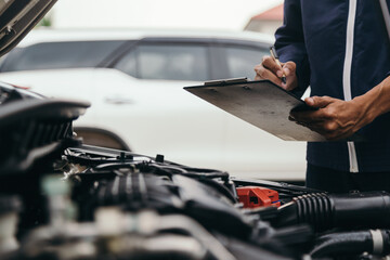 Automobile mechanic repairman hands repairing a car engine automotive workshop with a wrench, car service and maintenance,Repair service.
