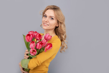happy girl smile hold flowers for spring holiday on grey background