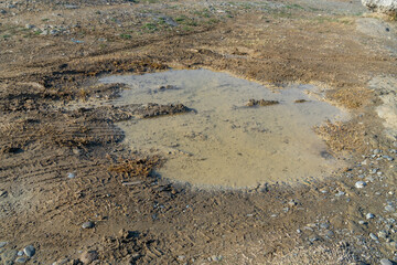 A bumpy wet gravel road after the rain
