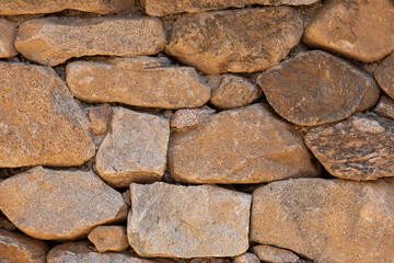 A stone wall texture found on the side of the road.