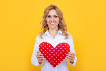 cheerful woman with red love heart on yellow background