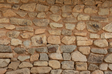 A stone wall texture found on the side of the road.