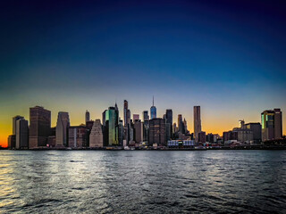 Fototapeta premium Panoramic view of beautiful sunset and colorful sky with Manhattan skyline in New York City.