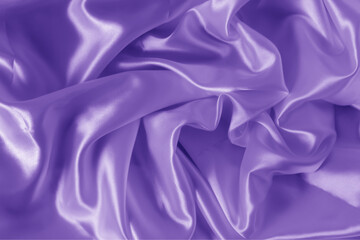 Obraz premium The texture of the proton purple cloth with waves and shrugs. Shiny fabric.