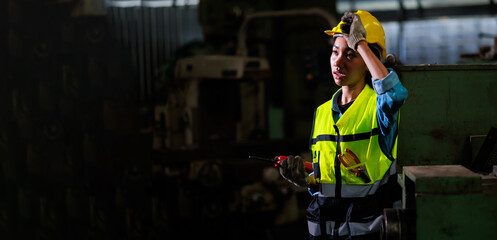 Tired and hot. Portrait african american female engineer worker wearing safety hard hat helmet. Metal lathe industrial manufacturing factory