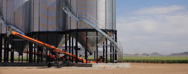 three grain silos in the field on a hot sunny day © Heidi Patricola