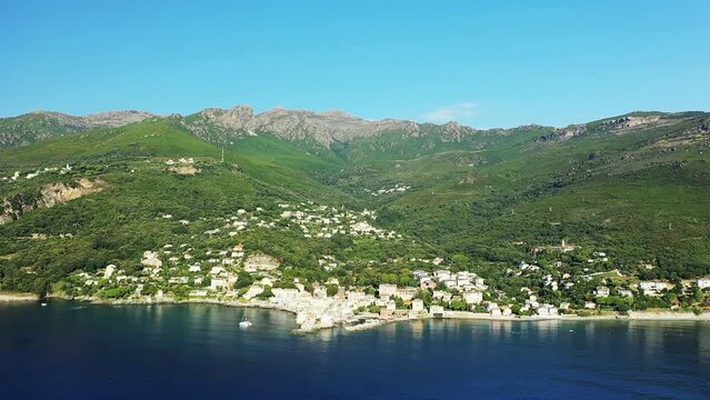 The city of Erbalunga in the middle of the arid and green mountains, in Europe, in France, in Corsica, towards Bastia, by the Mediterranean Sea, in summer, on a sunny day.