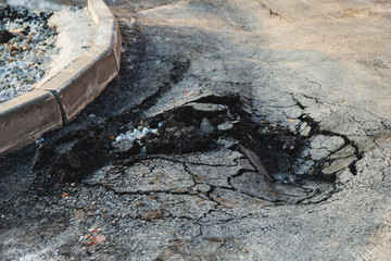 Asphalt swelling close-up. Pothole and pit on road
