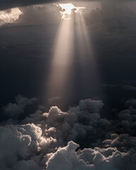 Sun breaking through clouds while flying.
Orange light with god rays