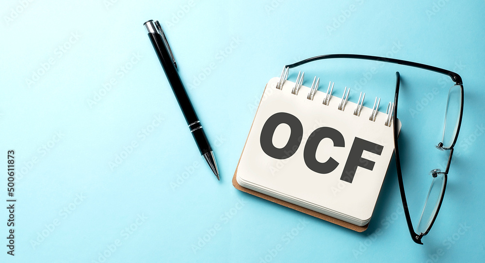 Poster oce text written on a notepad on the blue background