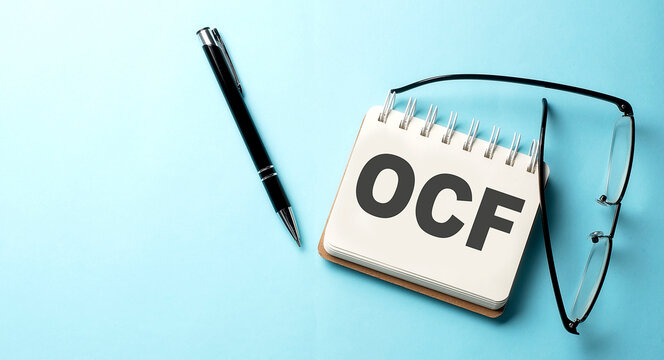 OCE text written on a notepad on the blue background