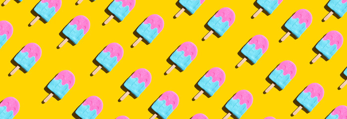 Pink and blue popsicles with shadow - overhead view - Powered by Adobe