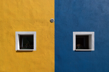 Colorful yellow and blue houses of Burano, Italy. Burano windows