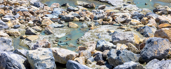 Panoramic view of colorful rocks and alkali water in Owens lake, California.