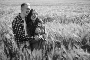 Young couple hugging in a barley field Black and white