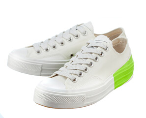 Fashionable sneakers made of snow-white cotton fabric, with a bright light green stripe in the back, with lacing, on a white sole, highlighted on a white background.