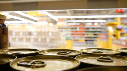 Fototapeta na wymiar Close-up of many beautiful tin cans on a supermarket shelf