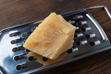 Close-up of a piece of parmesan. Hard cheese, food.