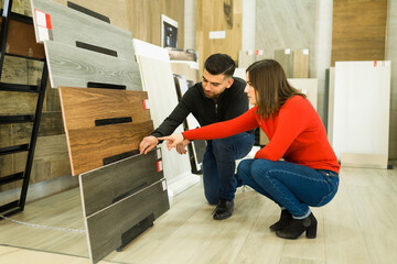 Obraz na płótnie Canvas Woman and man looking to buy new floors