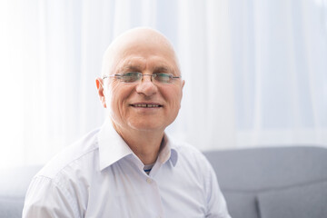Portrait of happy senior man smiling at home