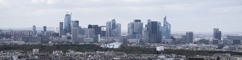Paris, France, Europe: aerial view of the city skyline with the skyscrapers of the La Defense, a business district with offices, condos and shopping centers, seen from the top of the Eiffel Tower