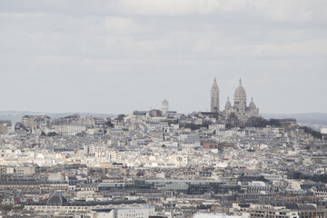 Fototapeta na wymiar Paris, France, Europe: aerial view from the top of the Eiffel Tower with Montmartre hill, the highest point in the city, and Basilica of the Sacred Heart, Roman Catholic church completed in 1914 