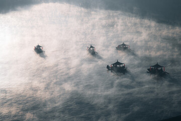 Fototapeta premium Sunrise with fog over Ban Rak thai, chinese village near a lake in Mae Hong Son, Thailand