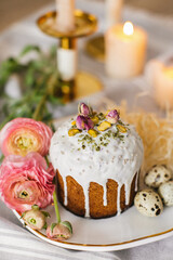 Delicious Easter cakes and eggs on white table with flowers 