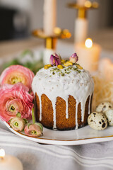 Delicious Easter cakes and eggs on white table with flowers 