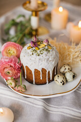 Delicious Easter cakes and eggs on white table with flowers 