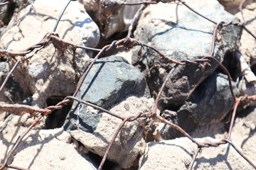 iron rusty net on the rocks