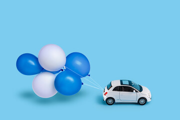 Toy car with Blue and white balloons. Concept of Independence Day of Israel.