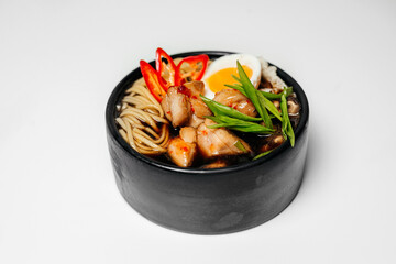 Ramen, noodle and egg soup, Asian food, Ramen in a black round plate, Ramen with chicken and mussels