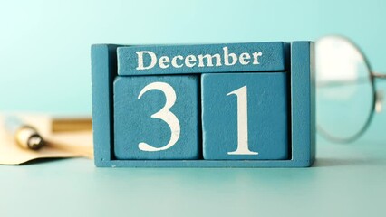 wooden calendar set on the 31 of December.