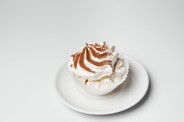 sweet dessert with whipped cream on a plate and sprinkled with chocolate