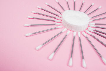 Cotton buds on a pink background