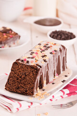 Sponge cake with white frosting and sugars.