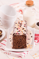 Sponge cake with white frosting and sugars.