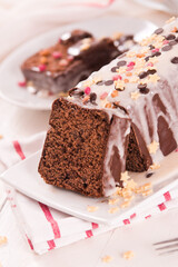 Sponge cake with white frosting and sugars.