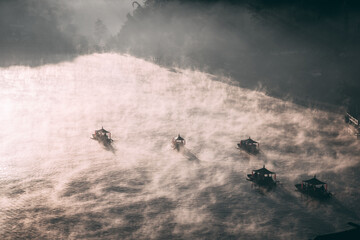 Fototapeta premium Sunrise with fog over Ban Rak thai, chinese village near a lake in Mae Hong Son, Thailand