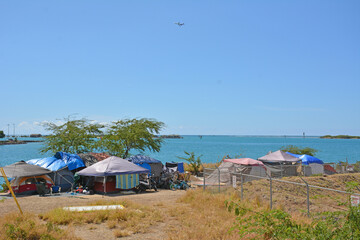 View of homeless encampment with tents at Sand Island in Honolulu Harbor on Oahu in Hawaii