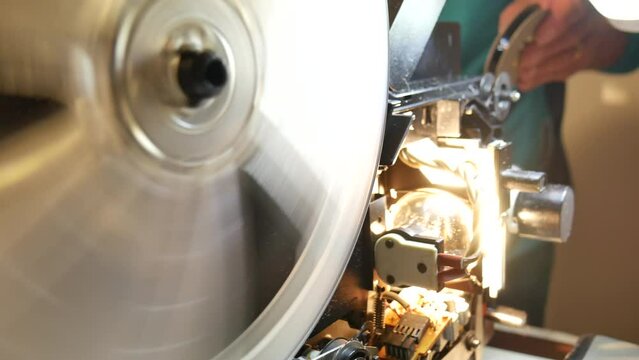 antique 8mm super projector with the coils spinning and the projector light on